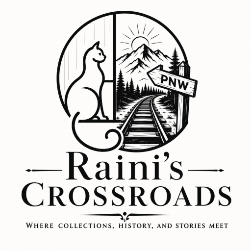 Image of Raini the cat sitting in a window looking out at Rainier and railroad tracks with a sign pointing to PNW
